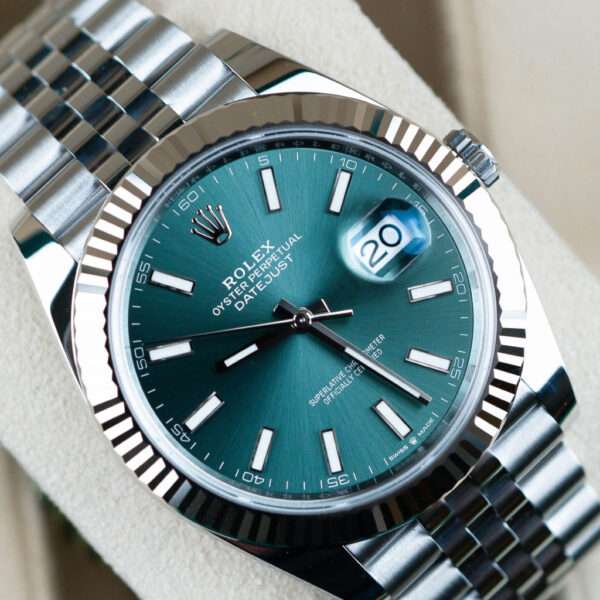 the Oyster Perpetual Datejust 41 in Oystersteel and white gold is a coveted addition to any collector's treasure trove. Featuring a mesmerizing mint green dial and an iconic Oyster bracelet, this timepiece exudes timeless elegance. www.stonehouse7.com